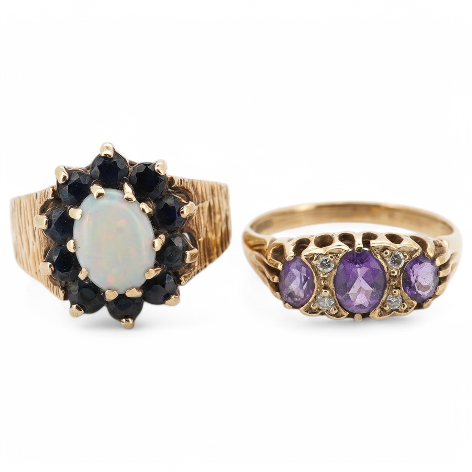 A 1970's textured 9ct gold, white opal and sapphire set oval cluster ring, size L, together with a modern 9ct gold and three stone amethyst set ring, with diamond chip spacers, size M/N, gross weight 7 grams. Condition -